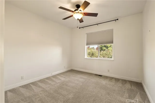 a bathroom with a granite countertop sink a toilet and a mirror