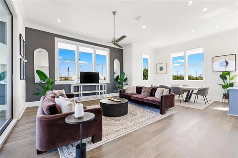 a living room with furniture and wooden floor