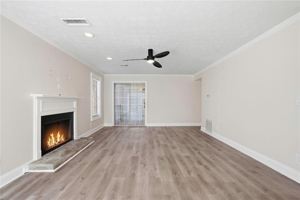 402 Countryside Place, Unit 402 Smyrna, GA 30080 - Photo 11 of 55 a view of empty room with wooden floor and fireplace