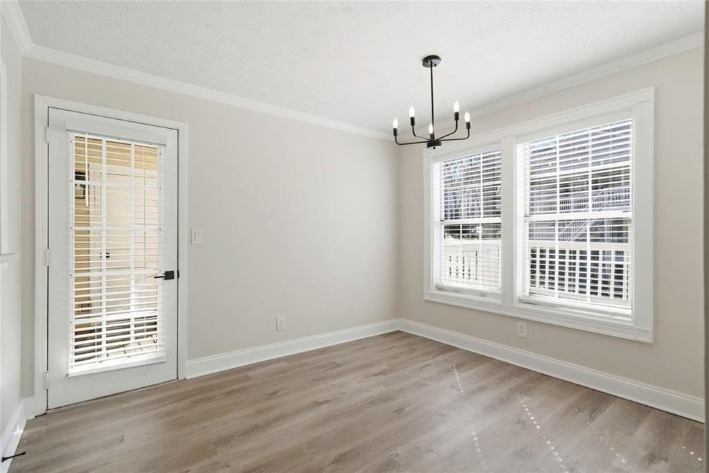 402 Countryside Place, Unit 402 Smyrna, GA 30080 - Photo 22 of 55 a view of an empty room with wooden floor and a window