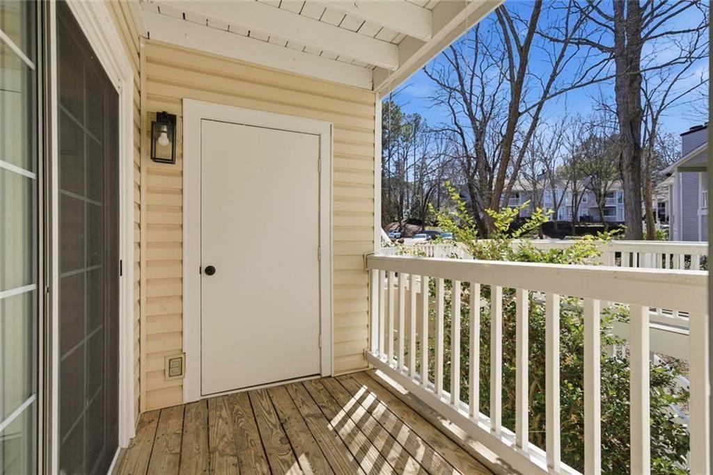 402 Countryside Place, Unit 402 Smyrna, GA 30080 - Photo 23 of 55 a view of a porch with wooden floor and fence
