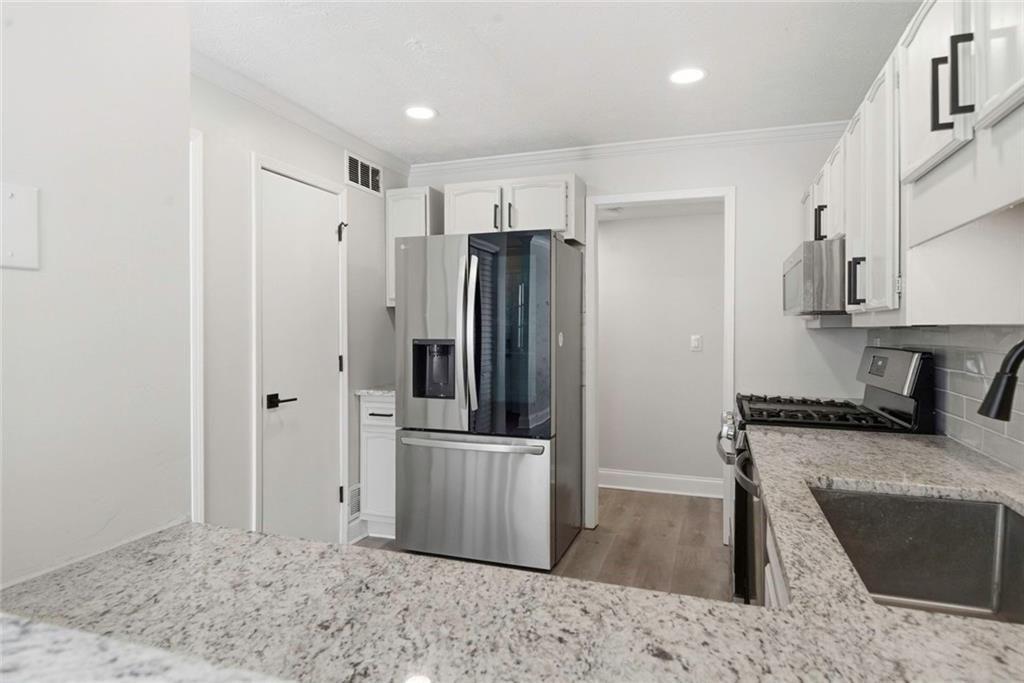 402 Countryside Place, Unit 402 Smyrna, GA 30080 - Photo 29 of 55 a kitchen with stainless steel appliances granite countertop a refrigerator and a sink