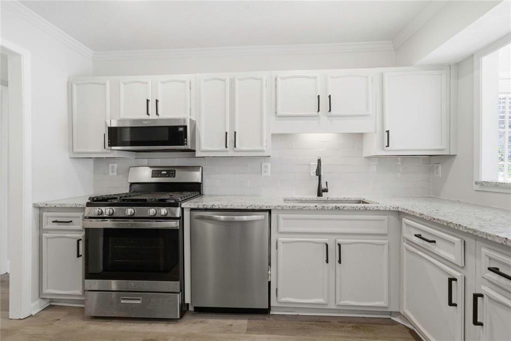 402 Countryside Place, Unit 402 Smyrna, GA 30080 - Photo 32 of 55 a kitchen with cabinets stainless steel appliances and wooden cabinets