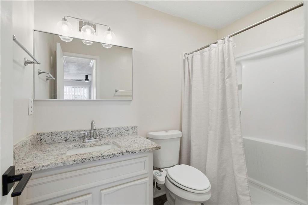 402 Countryside Place, Unit 402 Smyrna, GA 30080 - Photo 41 of 55 a bathroom with a granite countertop sink a toilet and a mirror