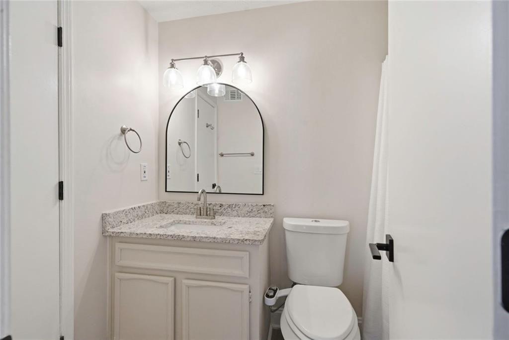 402 Countryside Place, Unit 402 Smyrna, GA 30080 - Photo 43 of 55 a bathroom with a granite countertop toilet sink and mirror