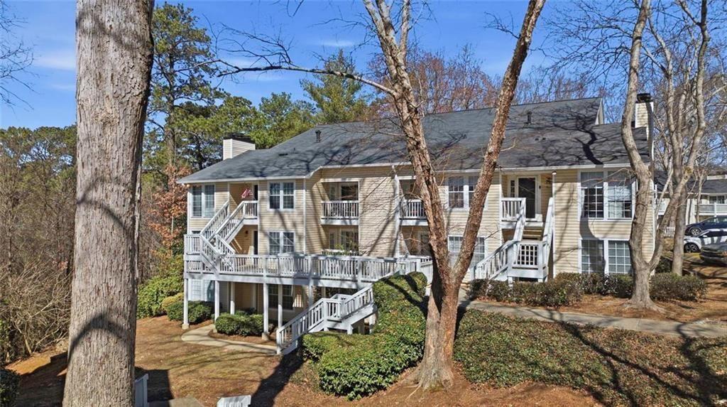 402 Countryside Place, Unit 402 Smyrna, GA 30080 - Photo 48 of 55 a front view of a house with large trees