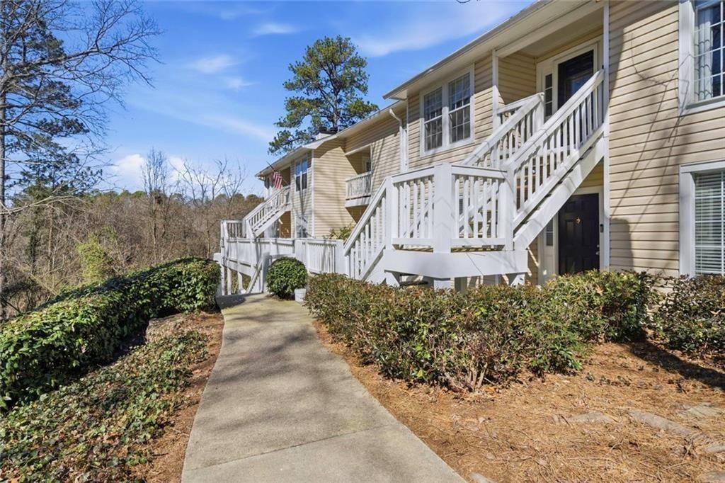 402 Countryside Place, Unit 402 Smyrna, GA 30080 - Photo 5 of 55 a front view of a house with a yard and potted plants
