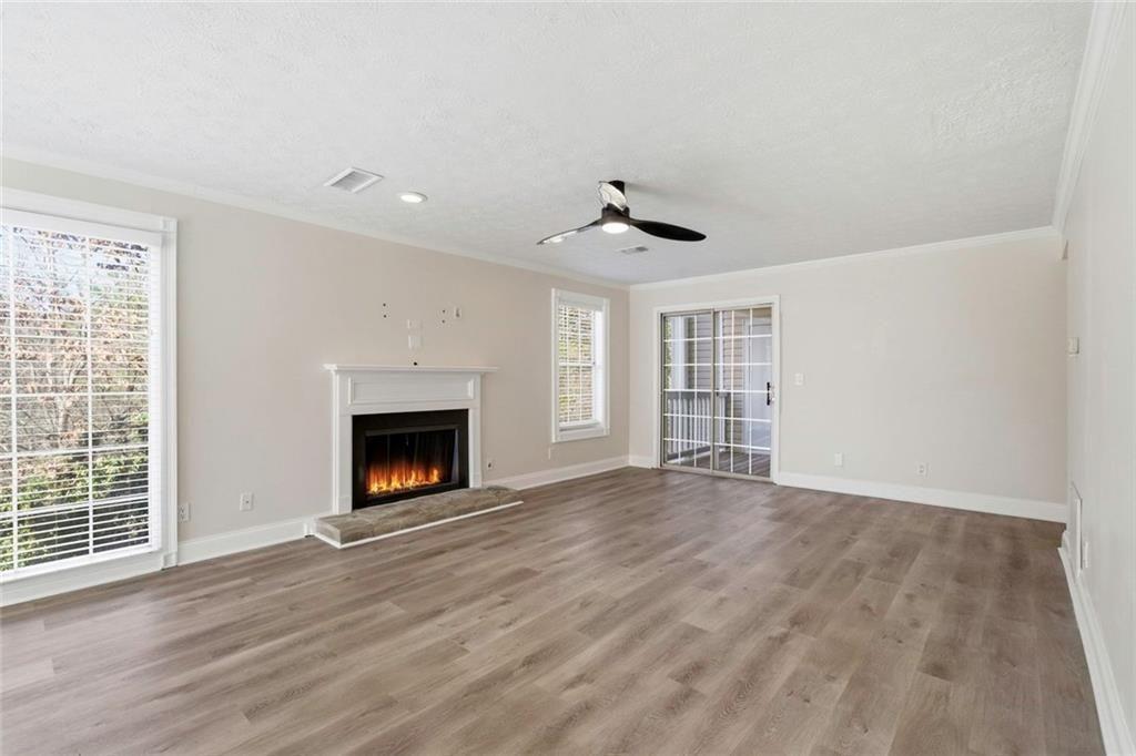 402 Countryside Place, Unit 402 Smyrna, GA 30080 - Photo 9 of 55 a view of an empty room with a fireplace and a window