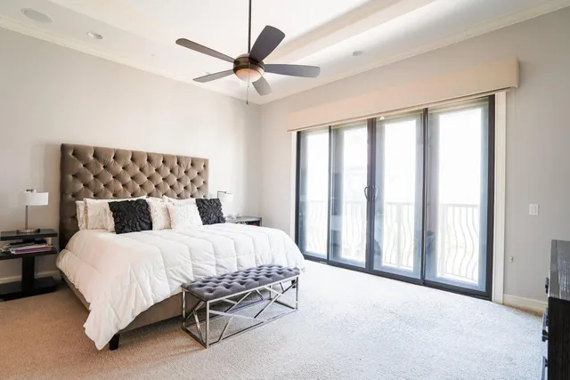 a bedroom with a bed and a large window