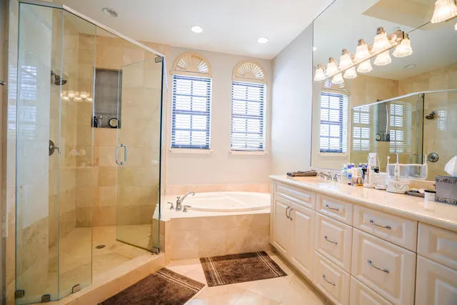 a bathroom with a double vanity sink toilet a shower and a bathtub