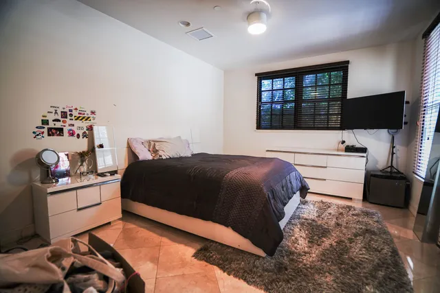 a bedroom with a bed and a window