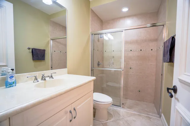 a bathroom with a sink a toilet and shower