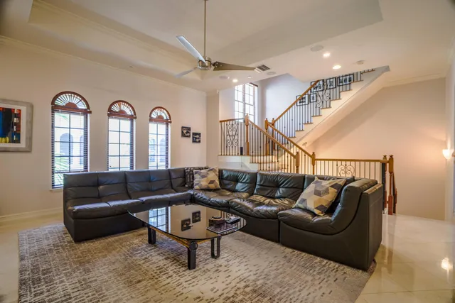 a living room with furniture ceiling fan and a rug