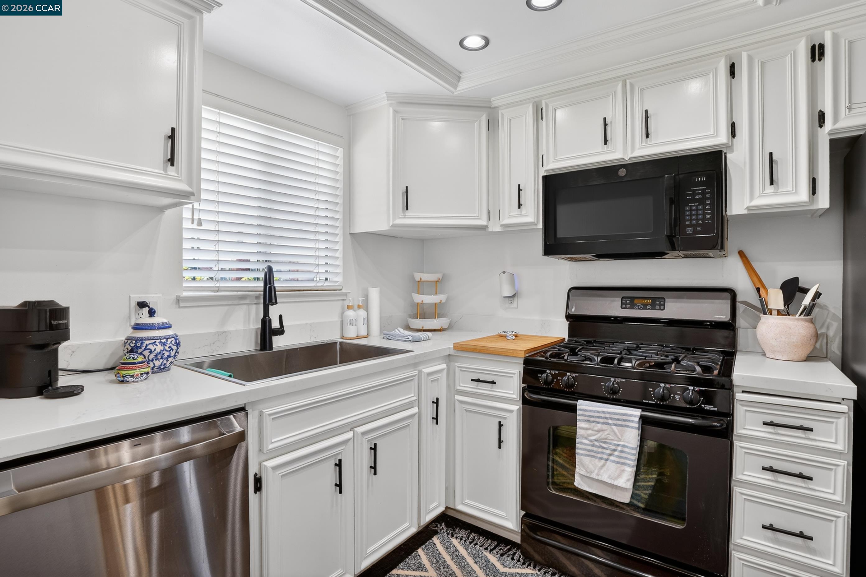 1812 Wildbrook Court, Unit C Concord, CA 94521 - Photo 17 of 35 a kitchen with cabinets appliances a sink and a window