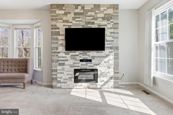 a living room with a fireplace a flat screen tv and a fireplace