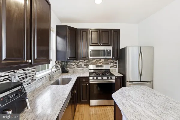 a kitchen with a refrigerator stove and sink