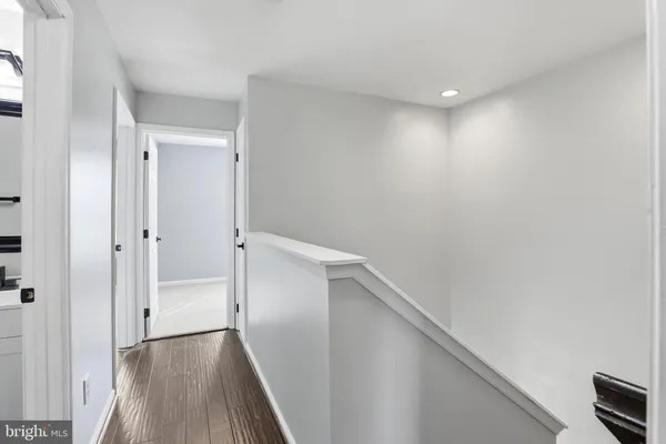 a view of a hallway with wooden floor