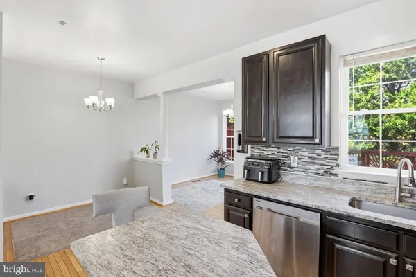 a kitchen with a sink and a stove top oven