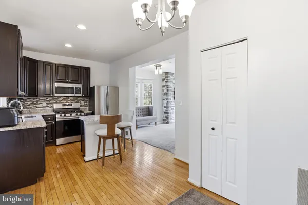 a kitchen with stainless steel appliances a refrigerator and a stove top oven