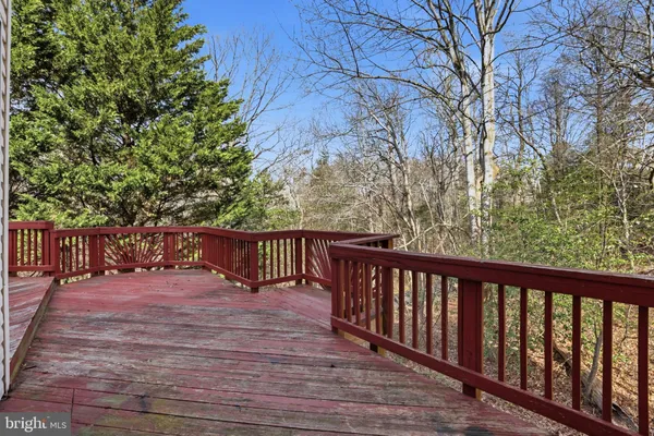 a view of a house with a balcony and wooden floor