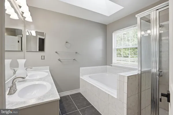 a bathroom with a sink a light fixture and a mirror