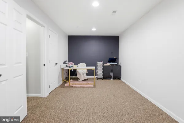a view of a hallway with wooden floor and stairs