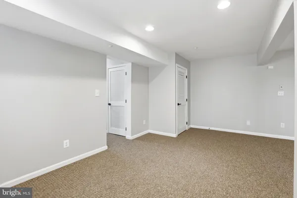 a white toilet sitting next to a bathroom sink