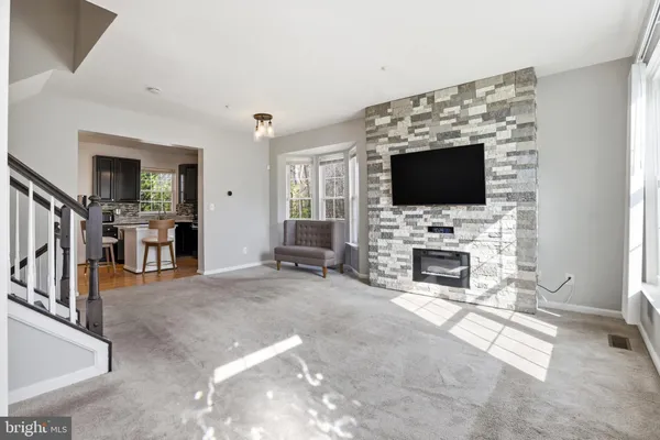 a living room with fireplace furniture and a flat screen tv