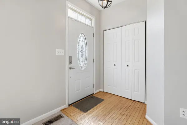a view of a room with wooden floor and white walls