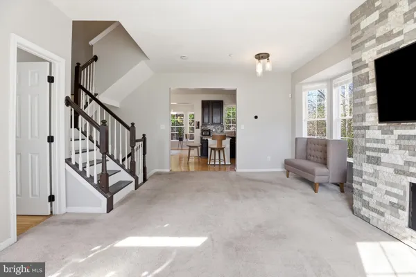 a living room with fireplace furniture and a flat screen tv
