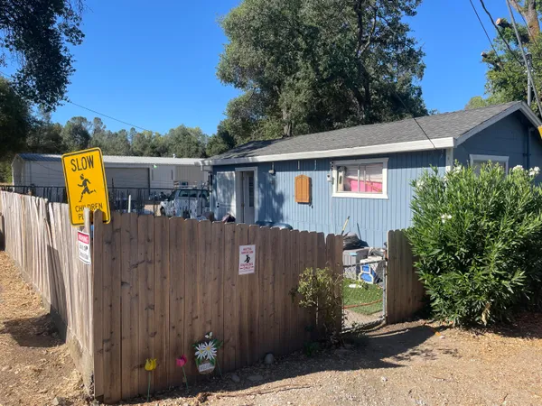 a view of a house with a backyard