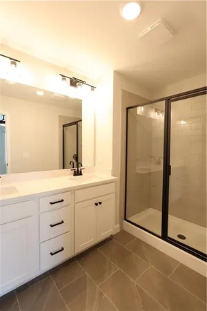 a spacious bathroom with a double vanity sink and a mirror