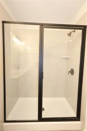 a bathroom with a glass shower door
