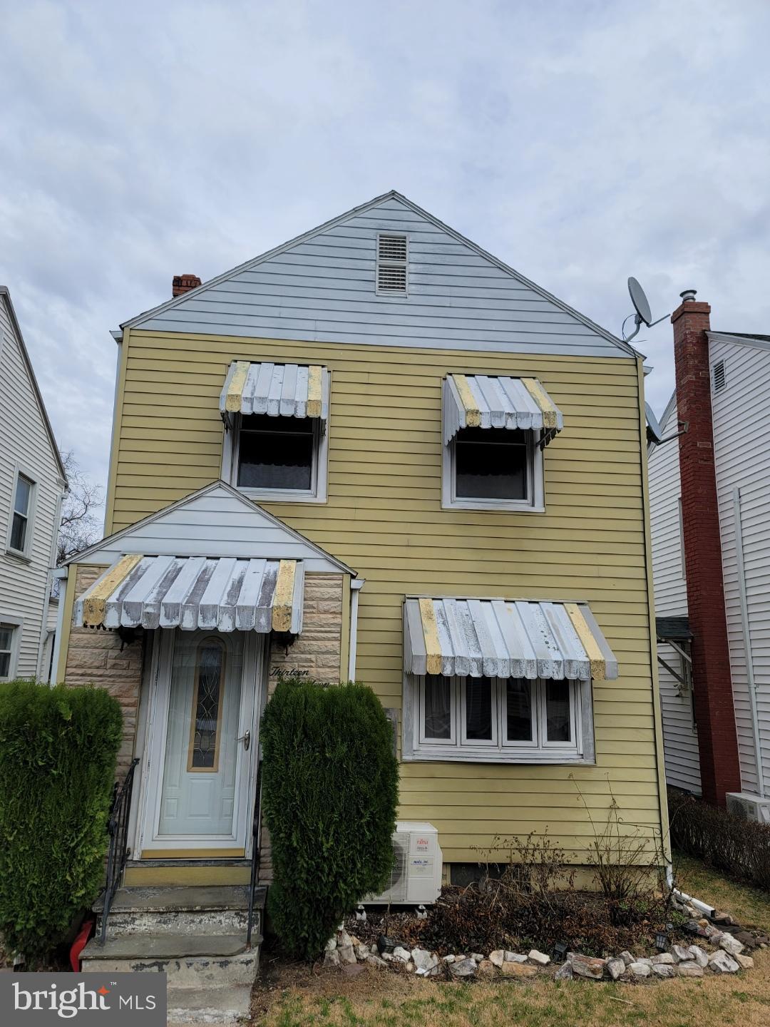 1319 Washington Street Huntingdon, PA 16652 - Photo 1 of 20 Charming yellow home with classic awnings.