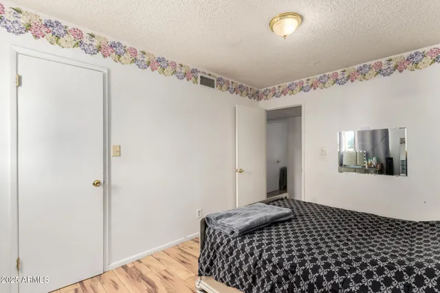 a bedroom with two beds and a window