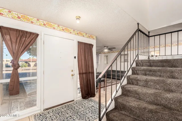 a view of staircase with wooden floor and a large window
