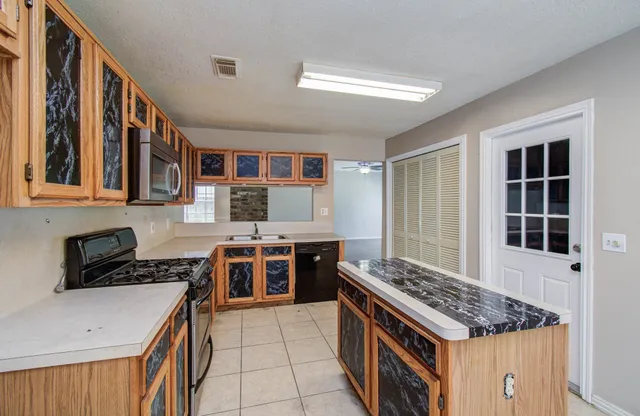 a kitchen with a stove and a sink