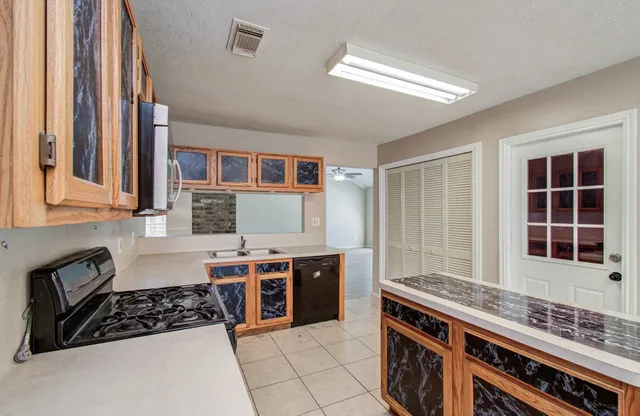 a kitchen with stainless steel appliances a stove and a sink