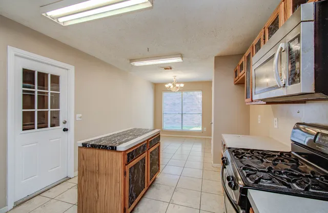 a kitchen with stainless steel appliances granite countertop a stove and a sink