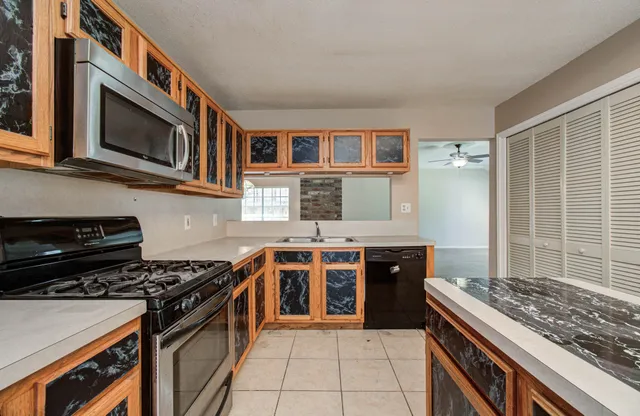 a kitchen with stainless steel appliances a stove and a microwave
