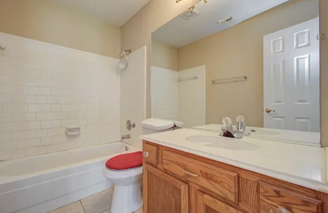 a bathroom with a sink toilet vanity and shower