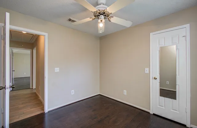 wooden floor in an empty room with a mirror