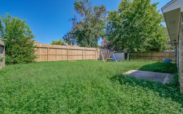 a view of backyard with a garden and trees