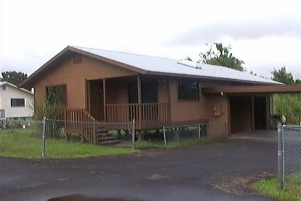 17-4006 Middle Road, Unit 102 Kurtistown, HI 96749 - Photo 1 of 15 a front view of a house with garden
