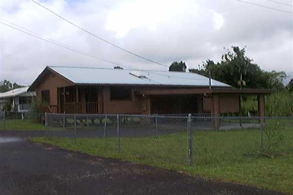 17-4006 Middle Road, Unit 102 Kurtistown, HI 96749 - Photo 2 of 15 a view of a house with a big yard and sitting area