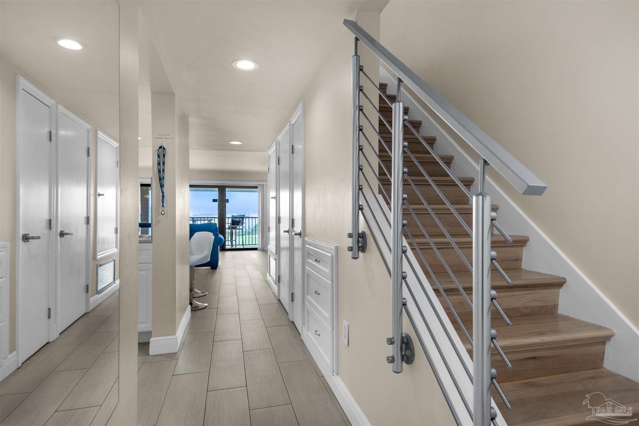 a view of hallway with stairs and wooden floor