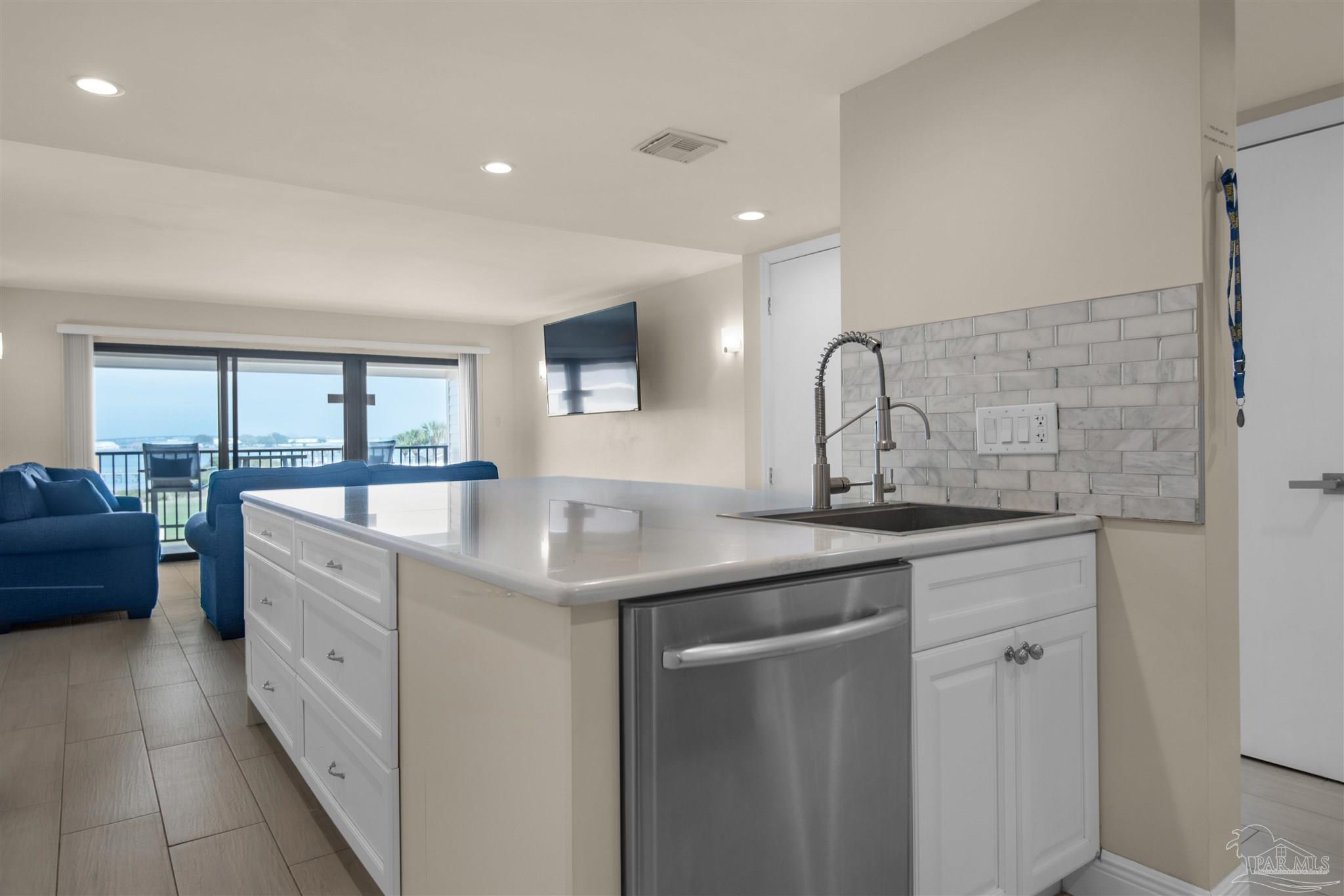 900 Fort Pickens Road, Unit 425 Pensacola Beach, FL 32561 - Photo 12 of 47 a spacious bathroom with a granite countertop sink a mirror and a bathtub