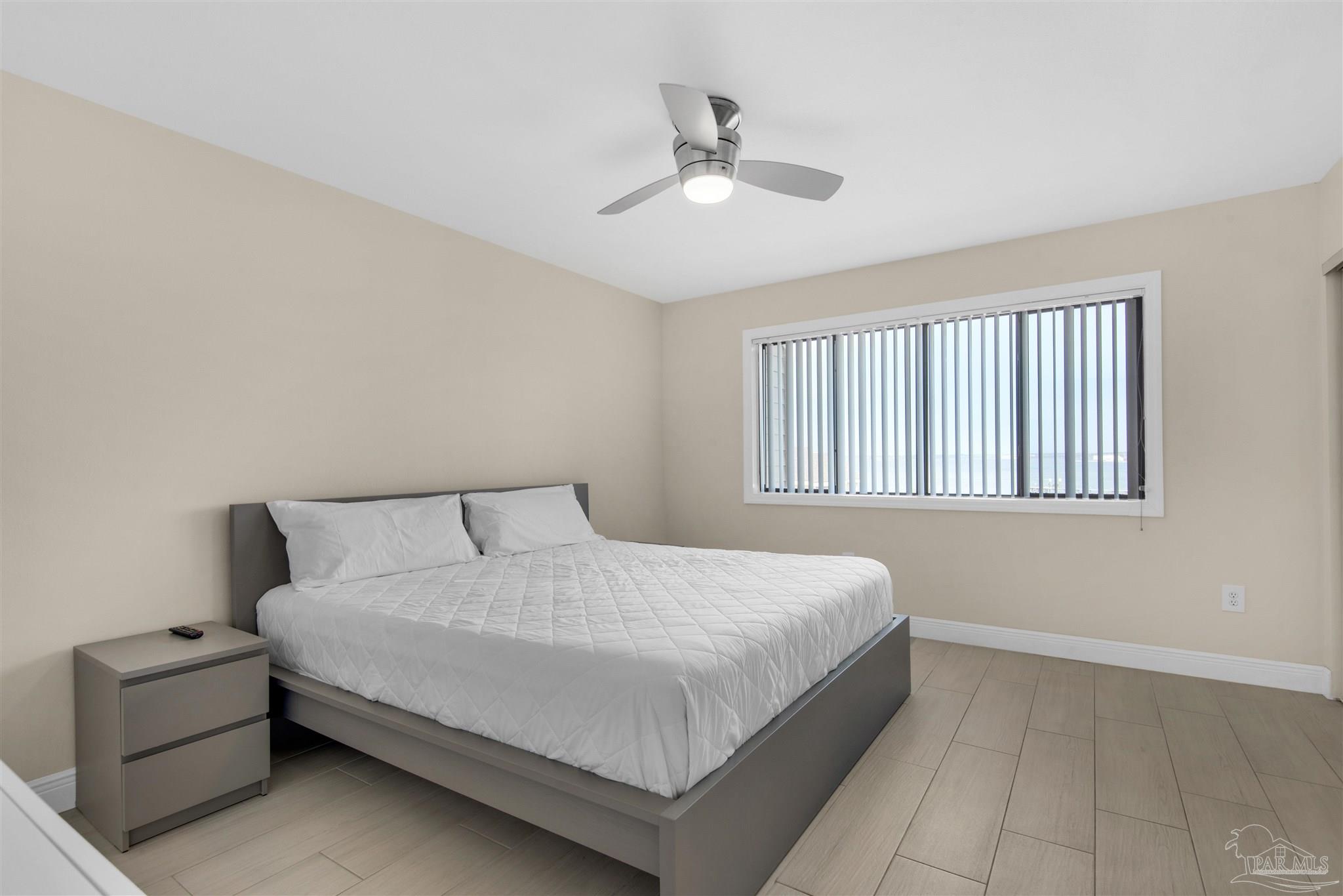 900 Fort Pickens Road, Unit 425 Pensacola Beach, FL 32561 - Photo 21 of 47 a large bed sitting in a bedroom next to a window