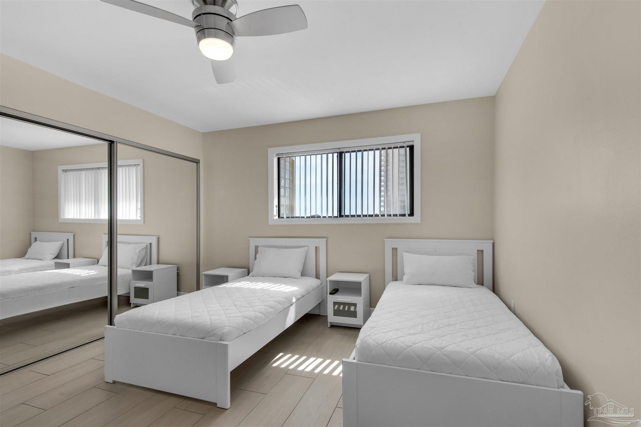 900 Fort Pickens Road, Unit 425 Pensacola Beach, FL 32561 - Photo 26 of 47 a bedroom with two beds and painting on the wall