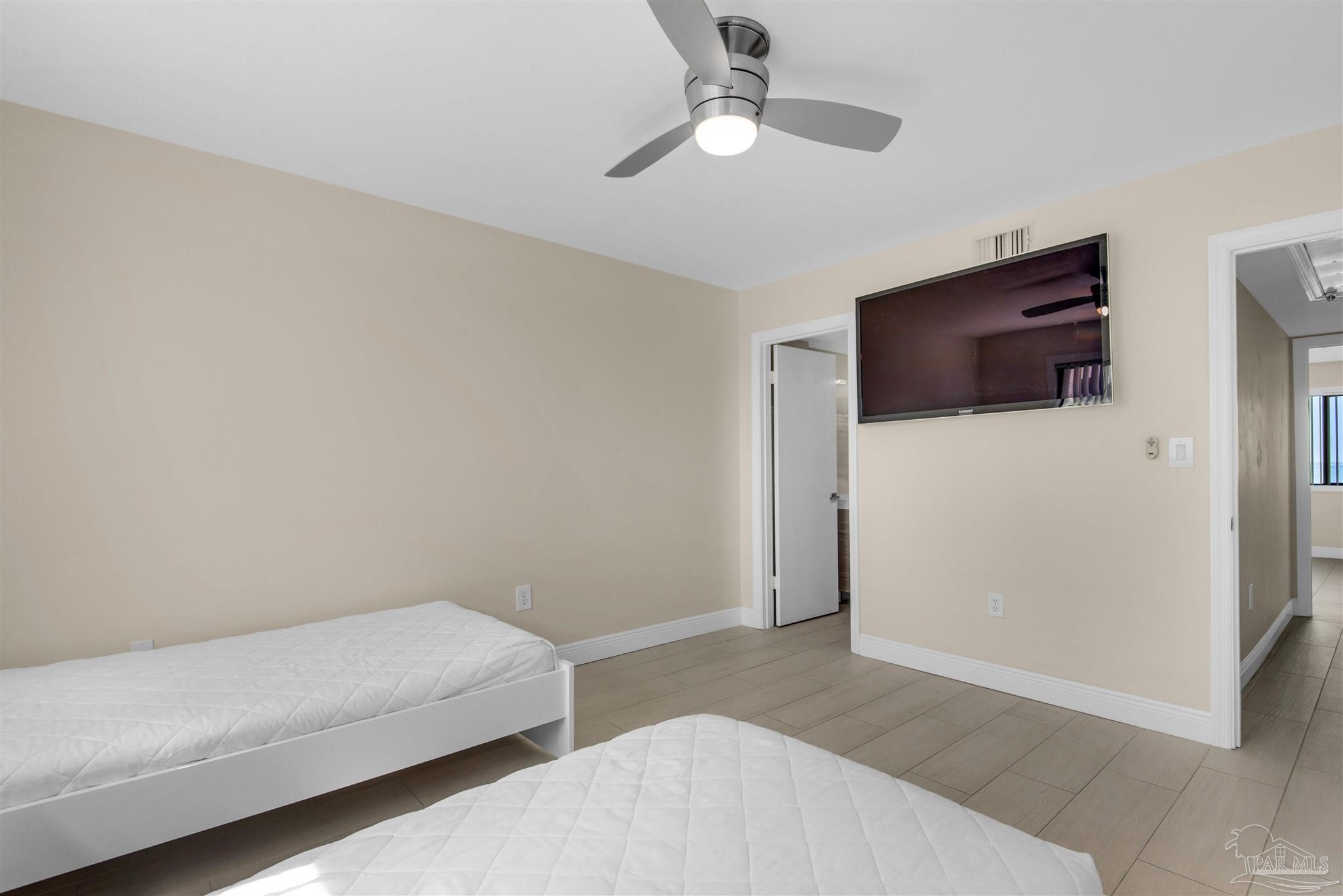 900 Fort Pickens Road, Unit 425 Pensacola Beach, FL 32561 - Photo 27 of 47 a bedroom with a bed and a flat screen tv